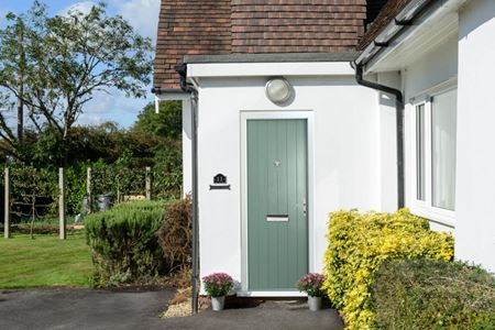 Cottage composite front door finished in Sage Green from the Anglian composite door range
