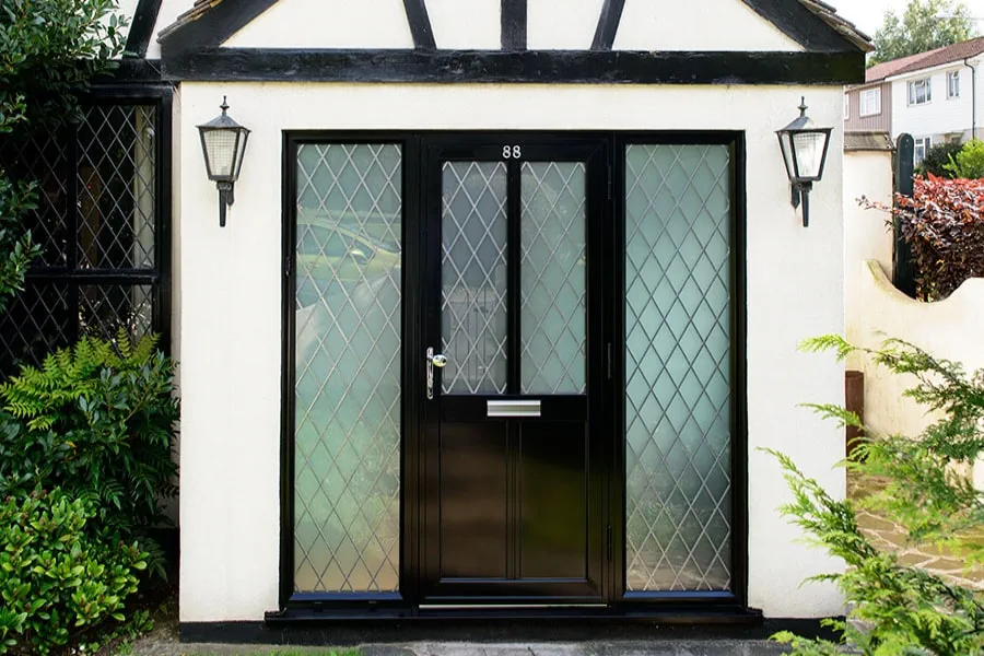 Black aluminium front door with leaded glass and side panels from the Anglian aluminium front door range
