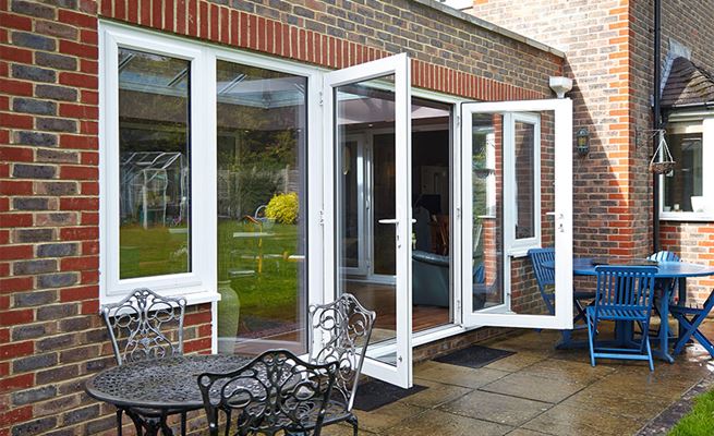 White UPVC French doors with large side double glazed windows from Anglian Home Improvements