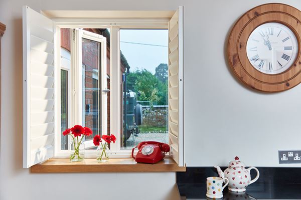 Dual White and Cream side-hung double glazed UPVC casement window from the Anglian casement window range