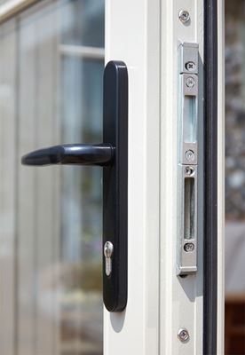 Close up of black door handle on white uPVC French doors from the Anglian French doors range