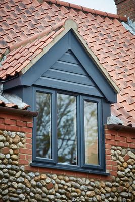 Anthracite Grey UPVC casement window with matching shiplap cladding from the Anglian windows and roofline range