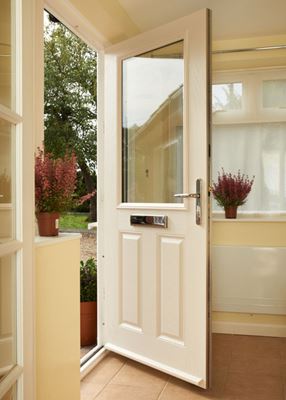 Interior view of open white woodgrain composite front door in traditional style half glazed from the Anglian composite doors range