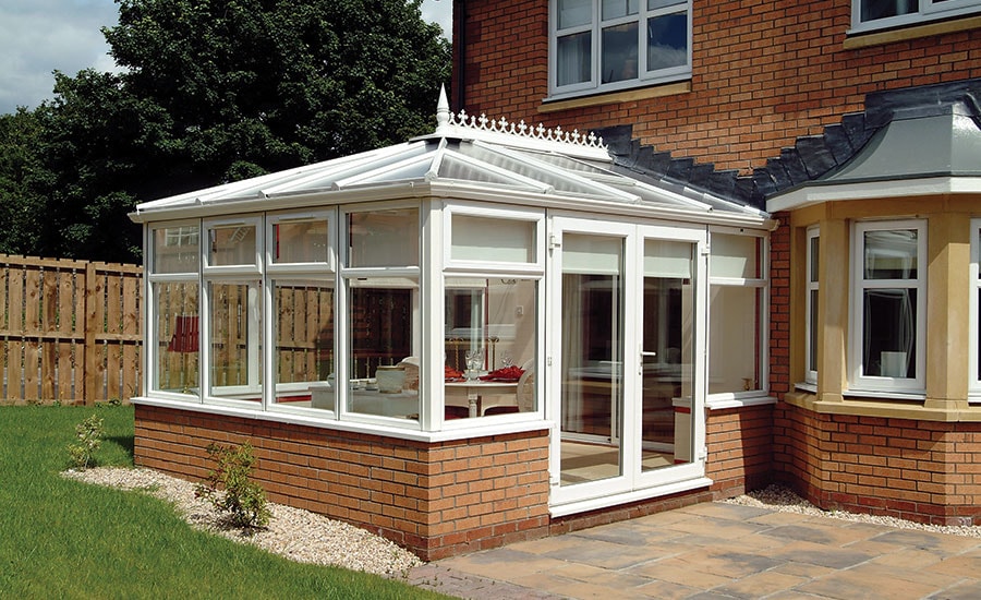 Elizabethan conservatory finished in White uPVC with French doors from the Anglian classic conservatories range