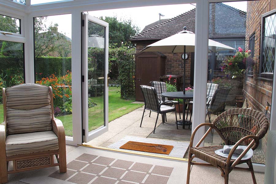 White uPVC Elizabethan conservatory interior with open French doors