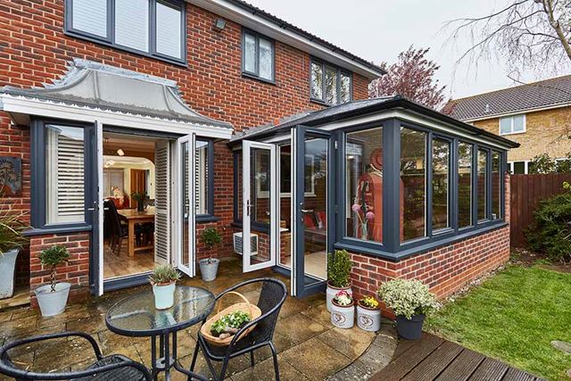 Replica tile extension Edwardian conservatory with dual anthracite grey French doors and windows
