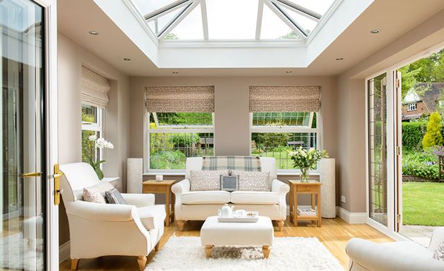 White UPVC orangery extension with square roof lantern and casement windows and French doors with leaded bars