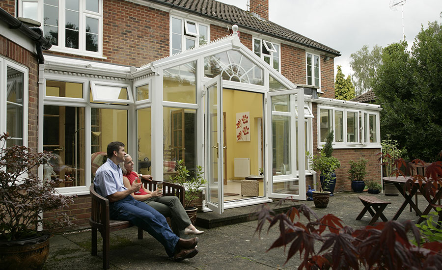 Exterior view of t-shaped conservatory in white UPVC from the Anglian conservatory range