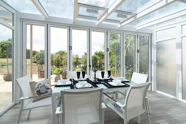White PVCU veranda conservatory interior with dining table