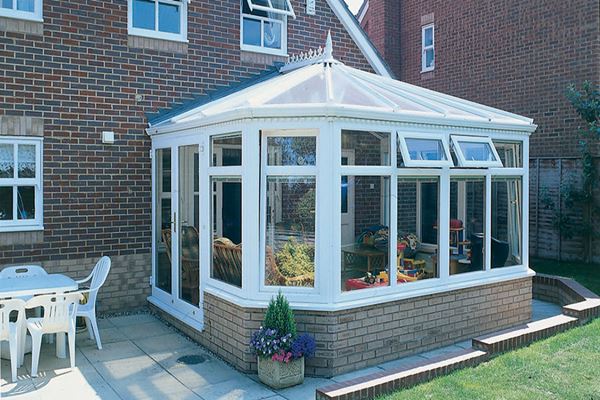 Victorian conservatory finished in White UPVC with French doors and classic finials from the Anglian classic conservatory range