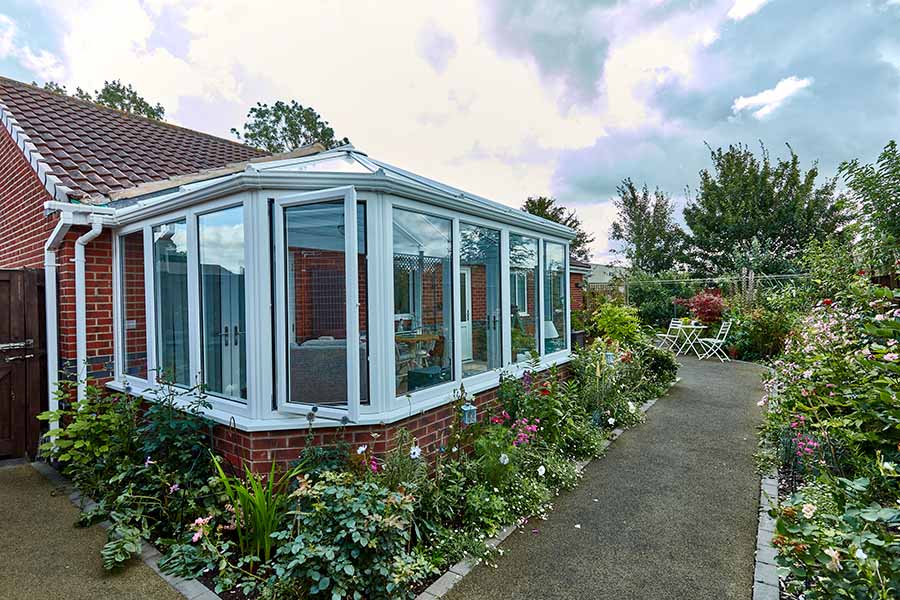 White uPVC Victorian conservatory with open window