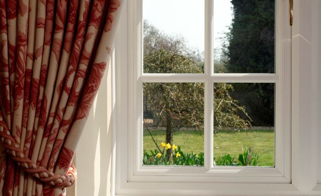 Close up of White double glazed wooden casement window with cottage bars from the Anglian wooden window range