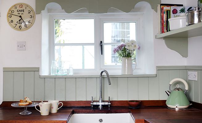 Narrow White cottage UPVC casement kitchen window with black window handle from the Anglian cottage window range
