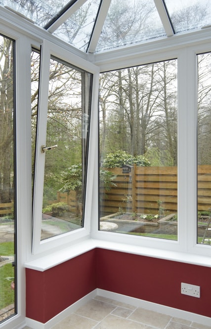 White uPVC Tilt & Turn window in tilt position within conservatory