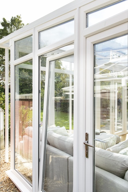 White uPVC Tilt & Turn window within a conservatory - in tilt position