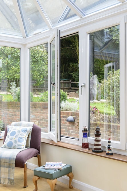 White uPVC Tilt & Turn window in the turn position within a conservatory