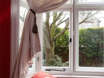 White secondary glazing with black handles form the Anglian secondary glazing range