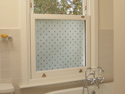 Bathroom sliding sash window with decorative obscure glass, made by Anglian Home Improvements