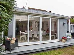 Rendered extension with white patio sliding doors from Anglian Home Improvements