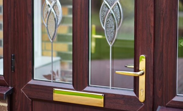 Front door in Dark Woodgrain with etched decorative glass design from Anglian Home Improvements