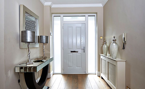 Interior view of White composite front door with side panels adding light to hallway