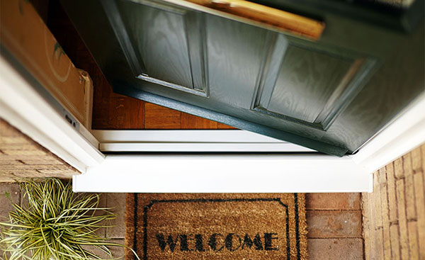 Traditional composite front door from Anglian Home Improvements and welcome doormat