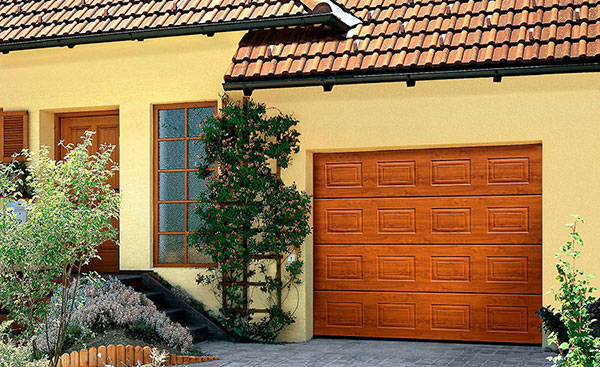 Georgian steel sectional garage door in Golden Oak woodgrain from the Anglian garage door range
