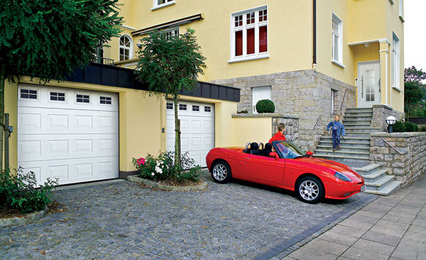 Pair of Georgian steel sectional garage doors in White with glazing from the Anglian garage door range