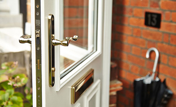 Close up of gold door handle and letterbox on UPVC front door