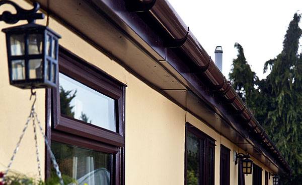 Dark Woodgrain uPVC fascias soffits and guttering from Anglian Home Improvements