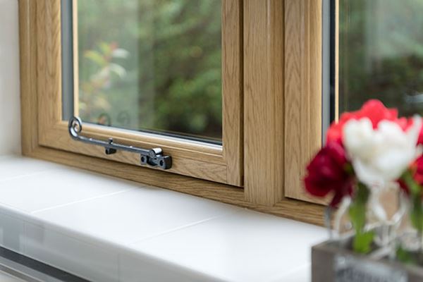 Close up of uPVC flush casement window in Golden Oak from Anglian Home Improvements