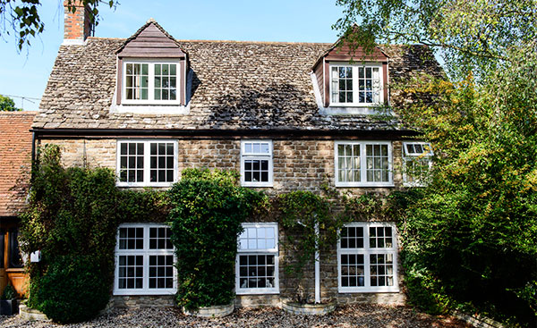 Whole house renovation of white cottage windows from Anglian Home Improvements