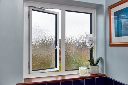 White aluminium casement bathroom window with obscure decorative glass from the Anglian aluminium windows range
