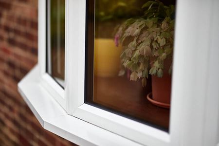 Close up of white aluminium bay window with double glazing from the Anglian aluminium windows range