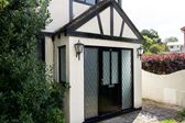 Black aluminium traditional front door with leaded glass and side panels from the Anglian front door range