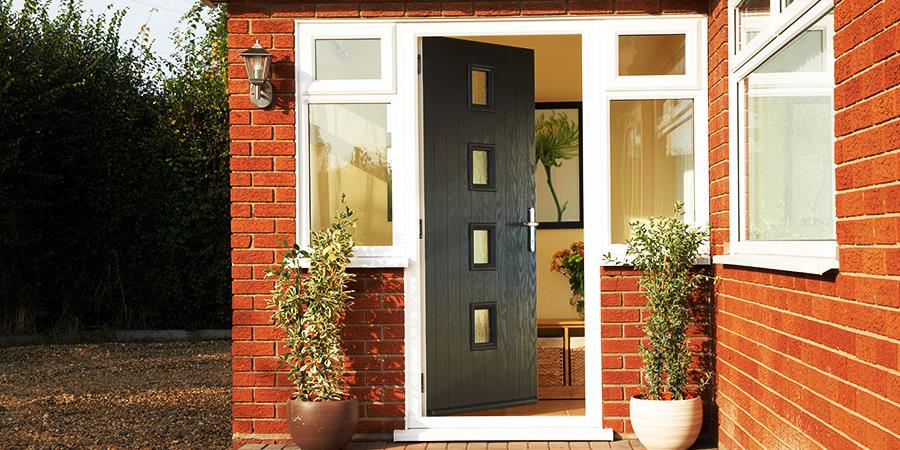 Black composite front door with step in contemporary style with double glazed side windows from Anglian Home Improvements