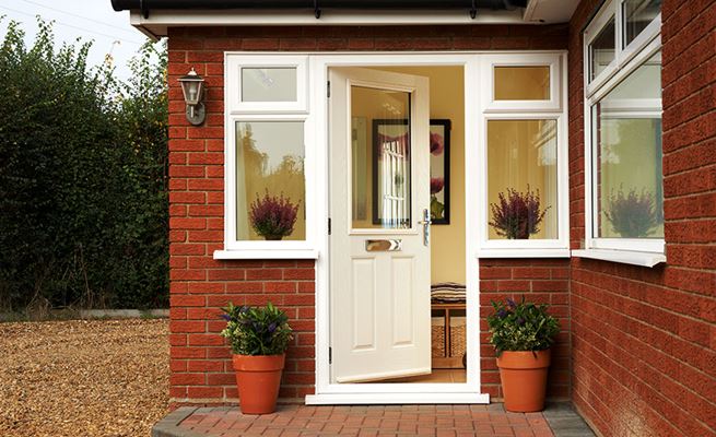 Cream composite front door in traditional style with chrome handle and letterbox from the Anglian front and back doors range