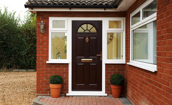 Traditional composite front door finished in Dark Woodgrain Canterbury design from the Anglian entrance doors range