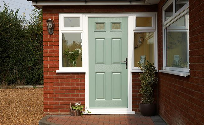 Sage Green composite front door in traditional style with top square glazed windows and Cotswold obscure glass