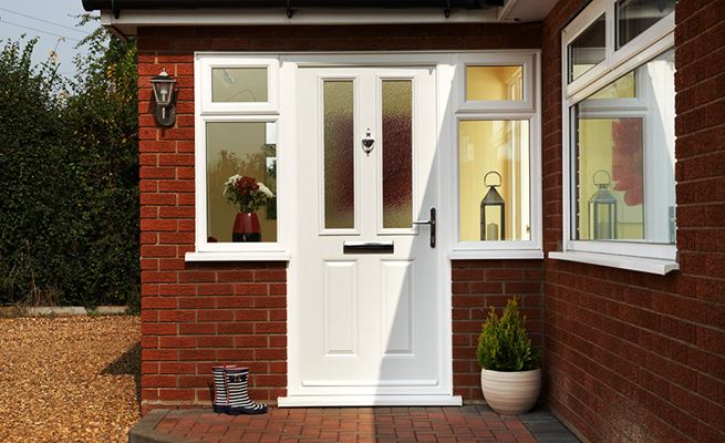 White composite front door with Minister glass and chrome handle knocker and letterplate from the Anglian traditional composite doors range