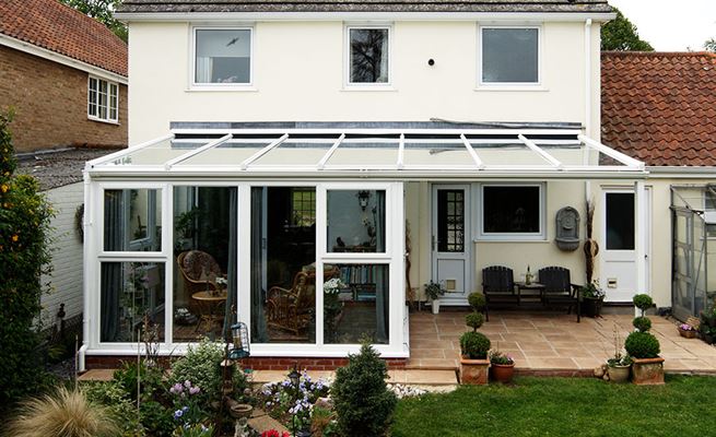 White UPVC lean to Veranda conservatory with large double glazed UPVC windows from the Anglian conservatories range