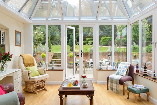 White UPVC Elizabethan conservatory with glass roof and large French doors interior living space view from the Anglian conservatories range