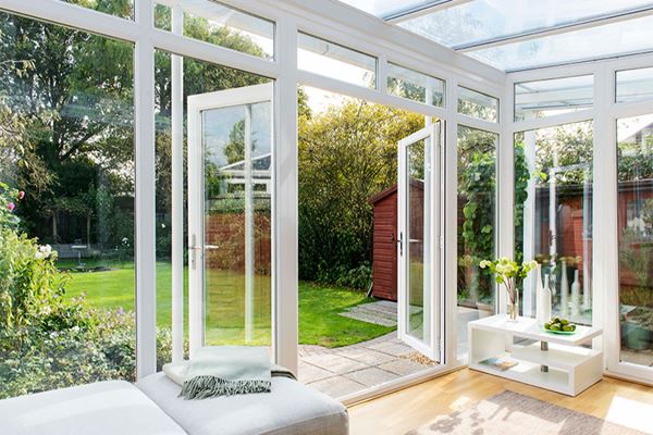 UPVC Veranda conservatory in White Knight with French doors opening onto garden from the Anglian conservatory range