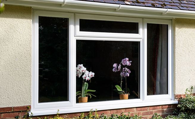 Double glazed UPVC casement window finished in White on bungalow from the Anglian double glazing range