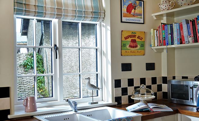 White wooden double glazed kitchen window with Georgian bars and black window handle from the Anglian timber window range