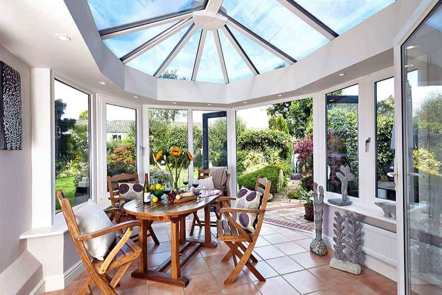 Modern dining room orangery extension with roof lantern finished in dual White and Anthracite Grey from the Anglian orangeries range