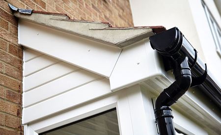 White Knight uPVC fascias and soffits with black guttering and downpipes