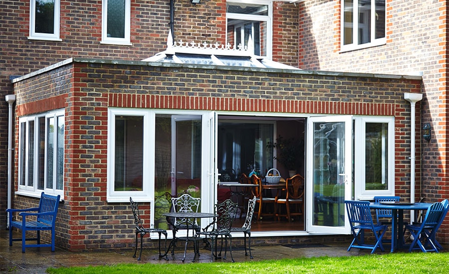 Brick orangery extension with White UPVC French double doors and windows from the Anglian orangeries range