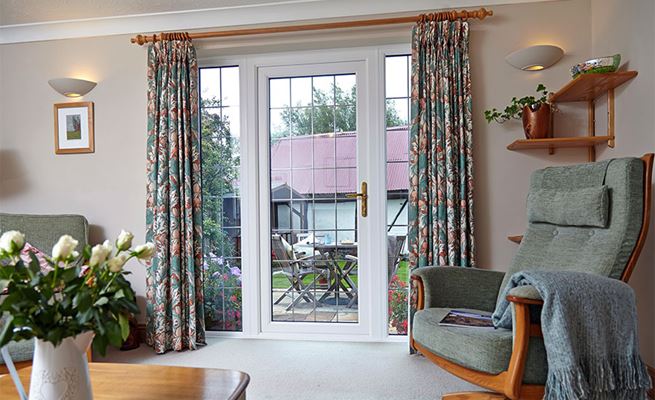 Dual Dark Woodgrain uPVC back door with decorative leaded glass from Anglian Home Improvements