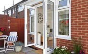 Pair of white uPVC French doors with chrome handles and hinges opening on modern patio